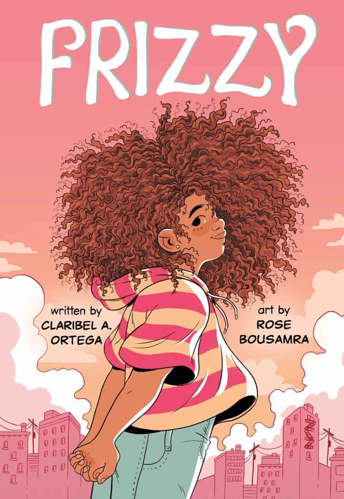Cover of Frizzy. A brown girl with a large amount of tight, coily, brown hair stands looking over her right shoulder in front of a sunset. She is smiling.